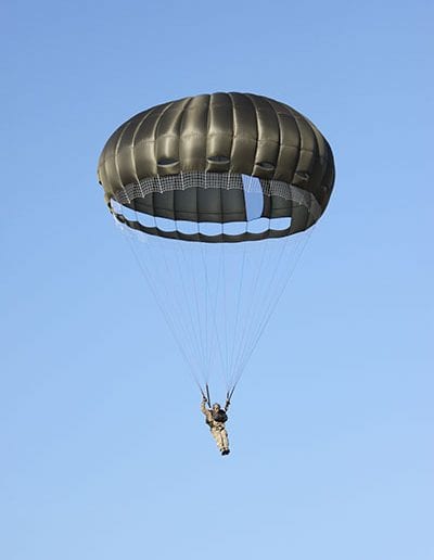 Man descending in an Invasion II Steerable parachute