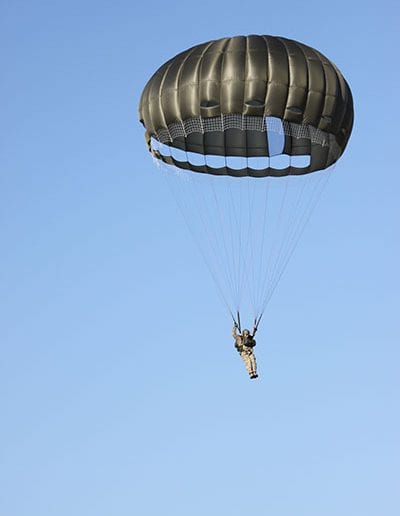 Man descending in an Invasion II Steerable parachute