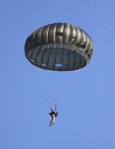 Man descending with Invasion II Non-Steerable parachute